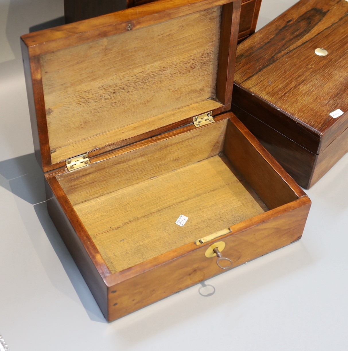 A Victorian rosewood jewellery casket, one other and a 19th century mahogany apprentice chest, height 25cm